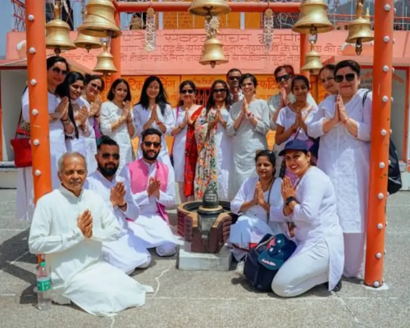 Yoga retreat group photo at a sacred temple site in Rishikesh