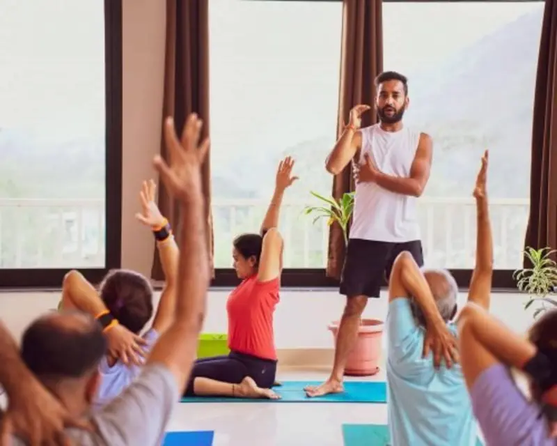 Yoga teacher training students practicing group yoga session