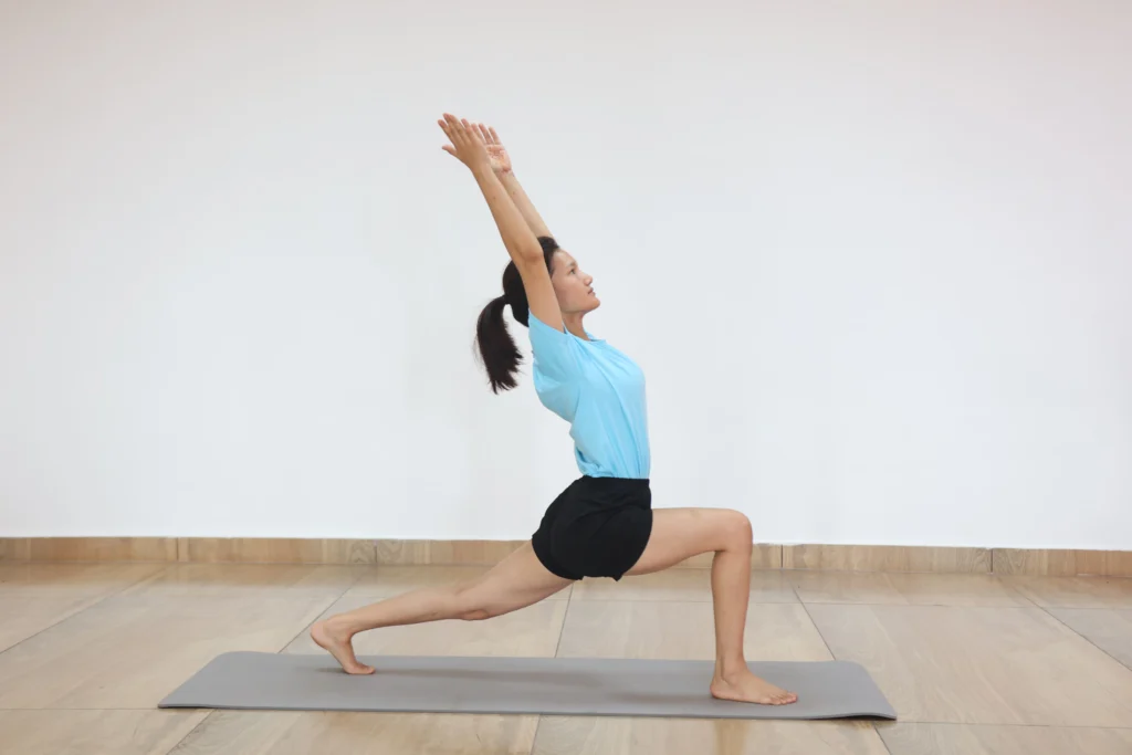 High crescent lunge pose stretching tight psoas and hip flexors caused by prolonged desk sitting